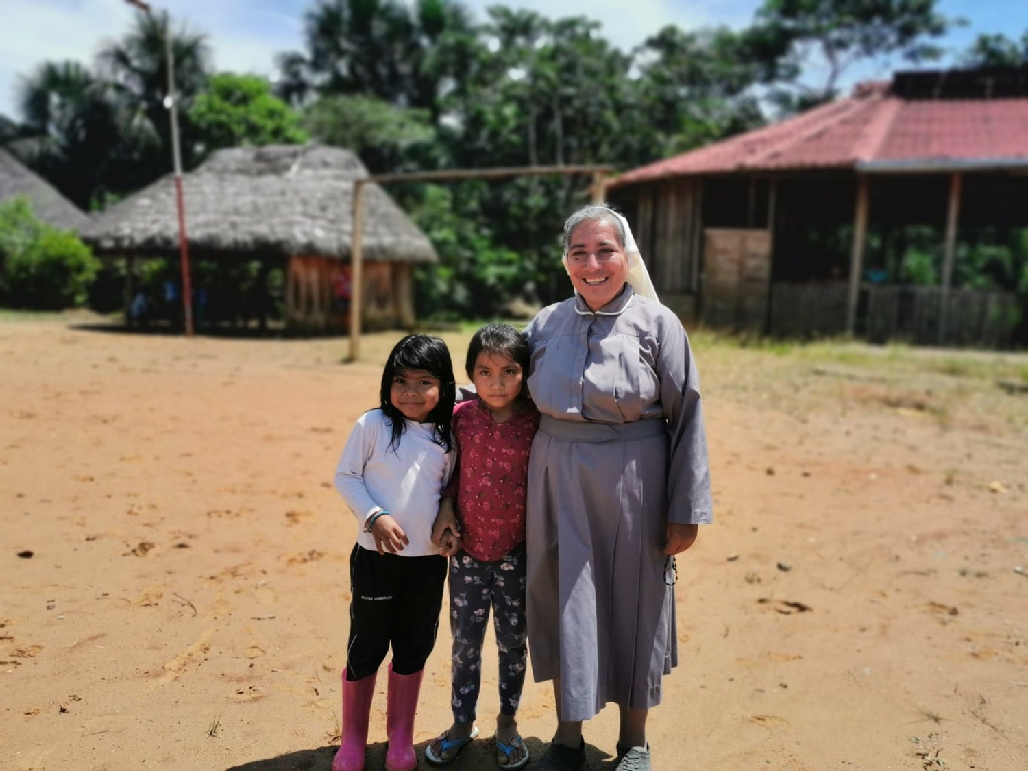 Sister Rosa Elena Pico, a member of the Missionaries of Mary Co-Redemptrix, poses for a photo with children from the indigenous community of Sarayaku, Ecuador, Sept. 18, 2019. Sister Pico has worked and lived with the community since 2017 and occasionally leads the liturgy of the word in the absence of a priest.